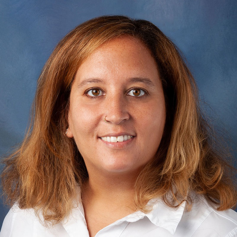 Headshot of Professor Berrocal. A womman with medium length light brown hair and hazel eyes