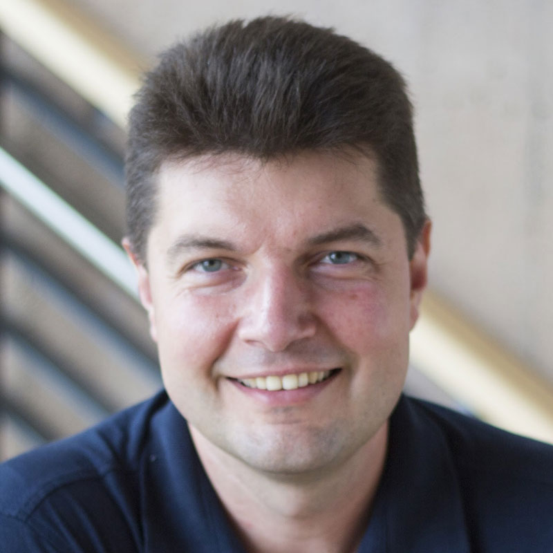 Headshot of Professor Minin. A man with light brown hair and blue eyes